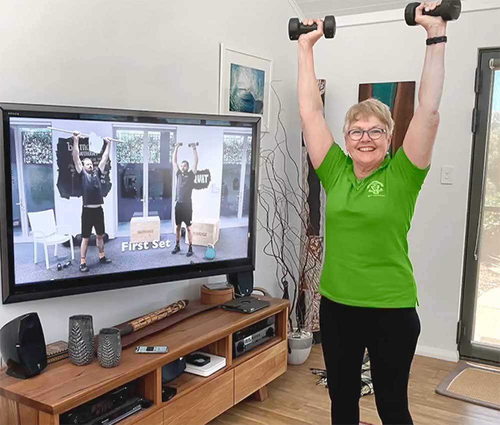 women in green shirt exercising